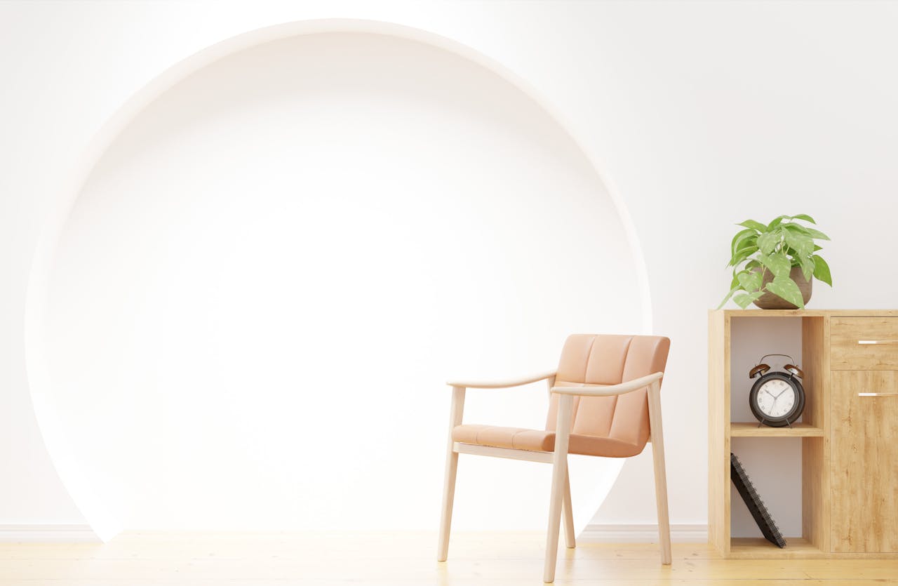Bright minimalistic interior featuring a lounge chair, wooden cabinet, and potted plant.