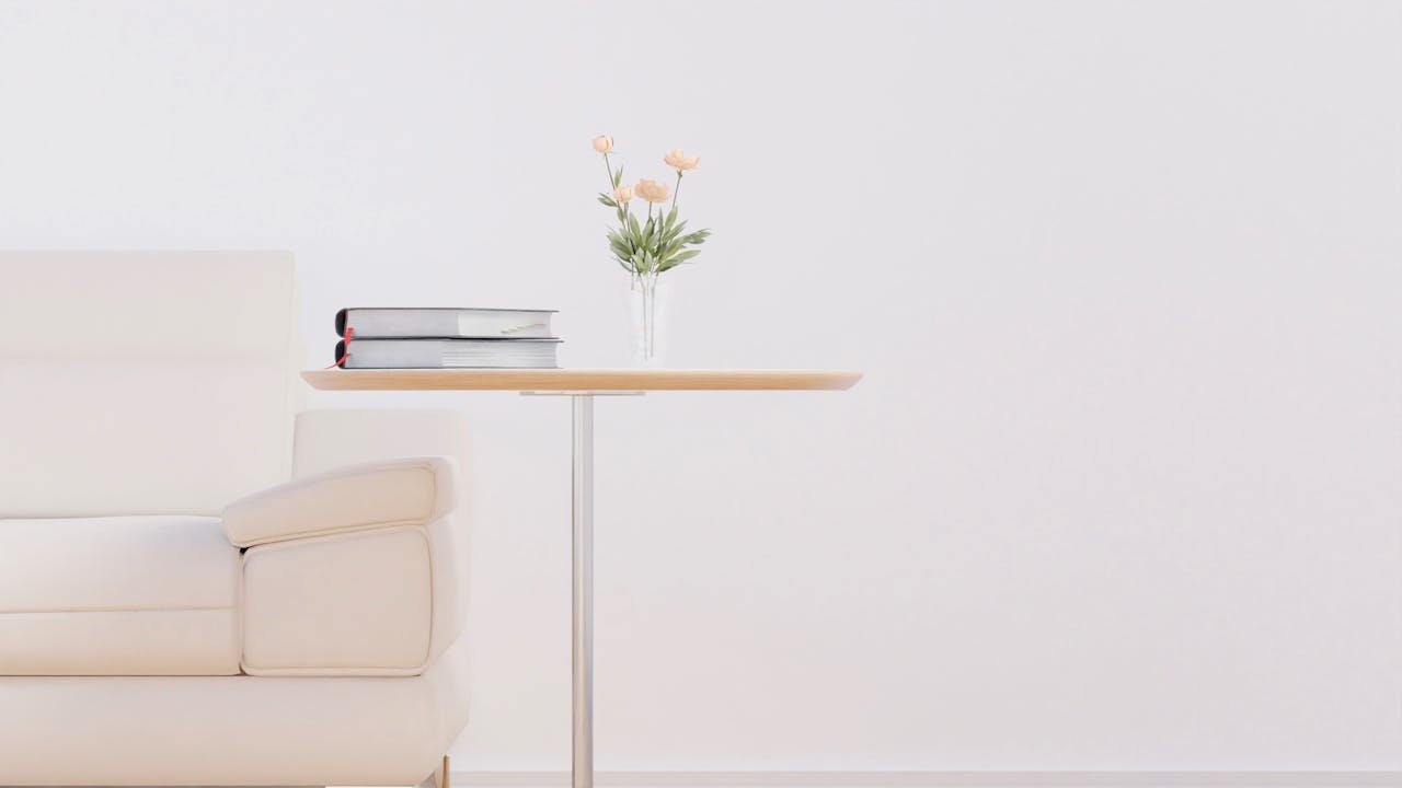 Stylish living room featuring a beige sofa, wooden table, and fresh flowers in a vase.