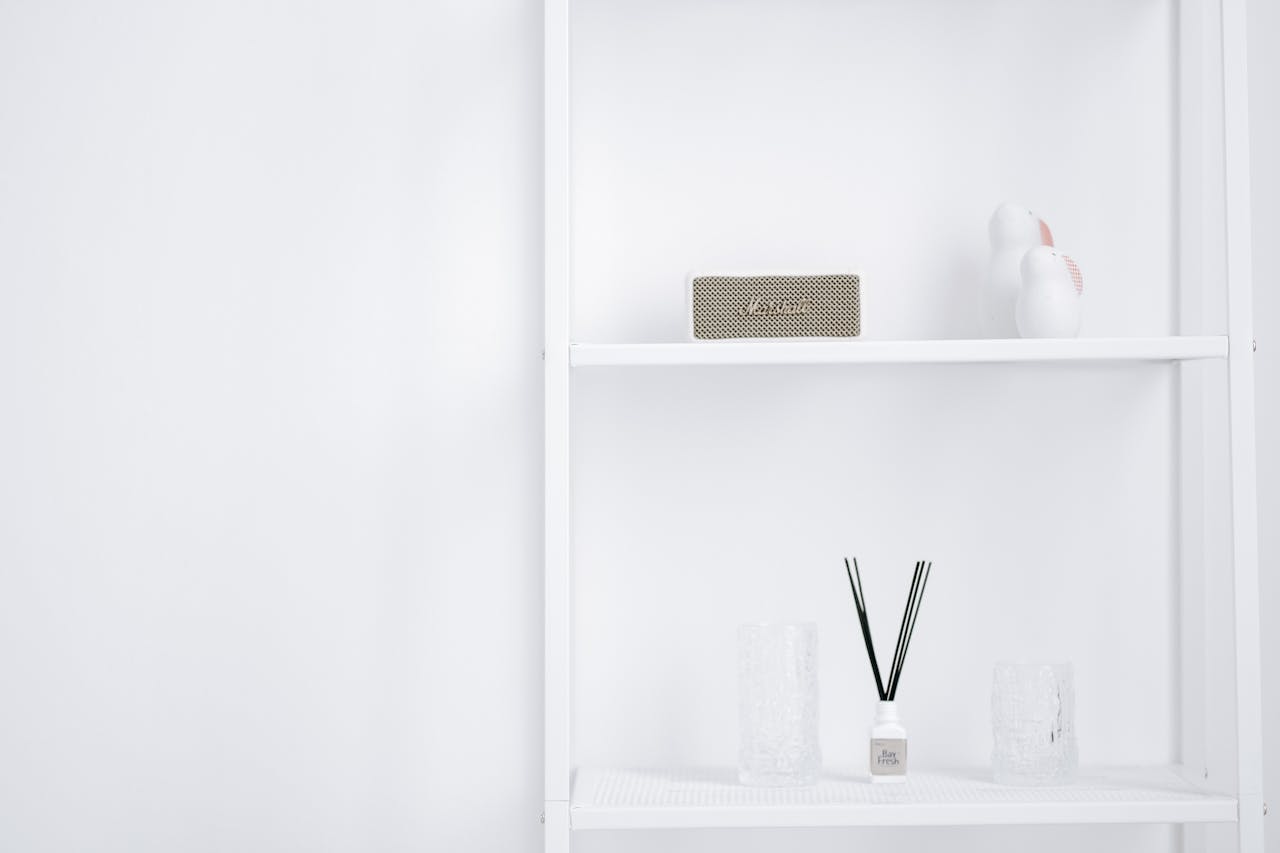 A neat white shelf with decorative items, displaying minimalistic interior style.